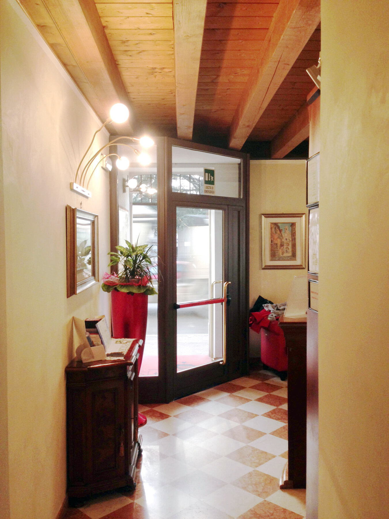 L’ingresso prima dei lavori, con la bussola esistente e il soffitto in travi di abete a vista